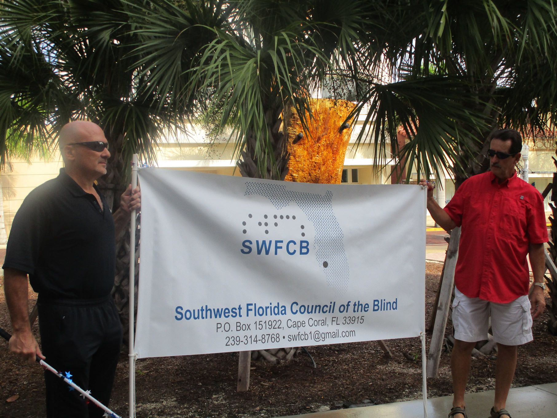 Will and Joe holding banner
